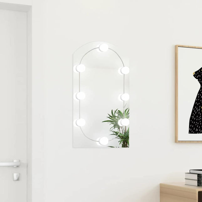 spejl med LED-lamper 70x40 cm buet glas