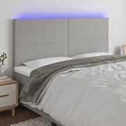 sengegavl med LED-lys 200x5x118/128 cm stof lysegrå
