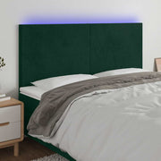 sengegavl med LED-lys 200x5x118/128 cm fløjl mørkegrøn