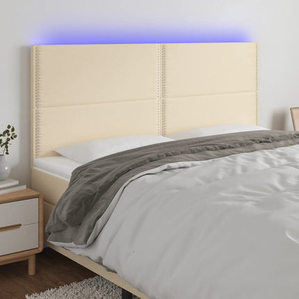 sengegavl med LED-lys 180x5x118/128 cm stof cremefarvet