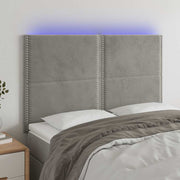 sengegavl med LED-lys 144x5x118/128 cm fløjl lysegrå