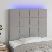 sengegavl med LED-lys 80x5x118/128 cm stof lysegrå