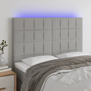 sengegavl med LED-lys 144x5x118/128 cm stof lysegrå