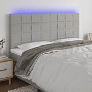 sengegavl med LED-lys 200x5x118/128 cm stof lysegrå