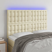 sengegavl med LED-lys 144x5x118/128 cm kunstlæder cremefarvet