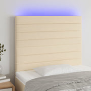 sengegavl med LED-lys 100x5x118/128 cm stof cremefarvet