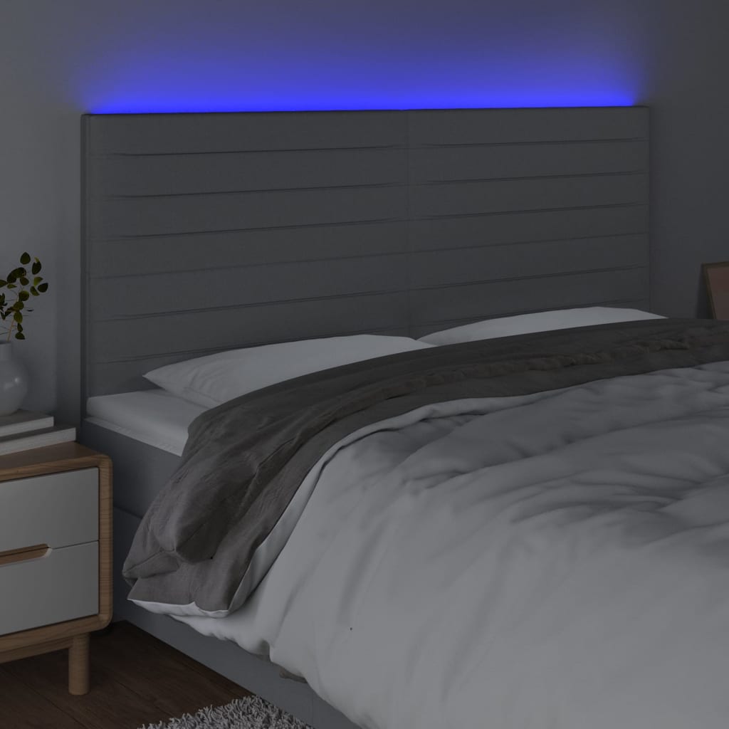 sengegavl med LED-lys 160x5x118/128 cm stof lysegrå