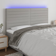 sengegavl med LED-lys 180x5x118/128 cm stof lysegrå