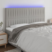 sengegavl med LED-lys 160x5x118/128 cm stof lysegrå