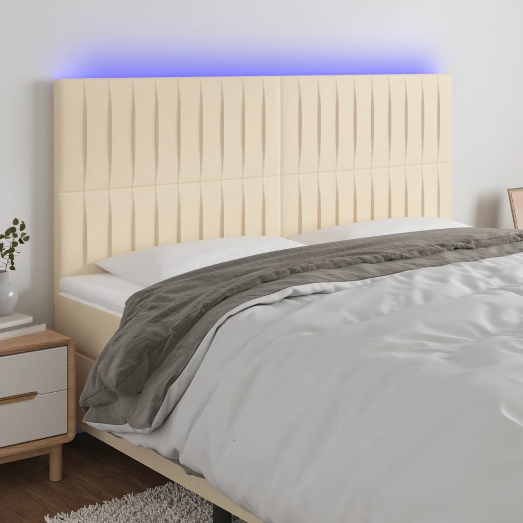 sengegavl med LED-lys 200x5x118/128 cm stof Cremefarvet