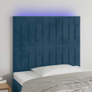 sengegavl med LED-lys 100x5x118/128 cm fløjl mørkeblå