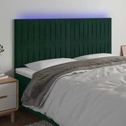 sengegavl med LED-lys 160x5x118/128 cm fløjl mørkegrøn
