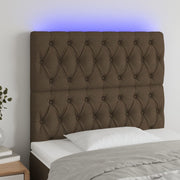 sengegavl med LED-lys 100x7x118/128 cm stof mørkebrun