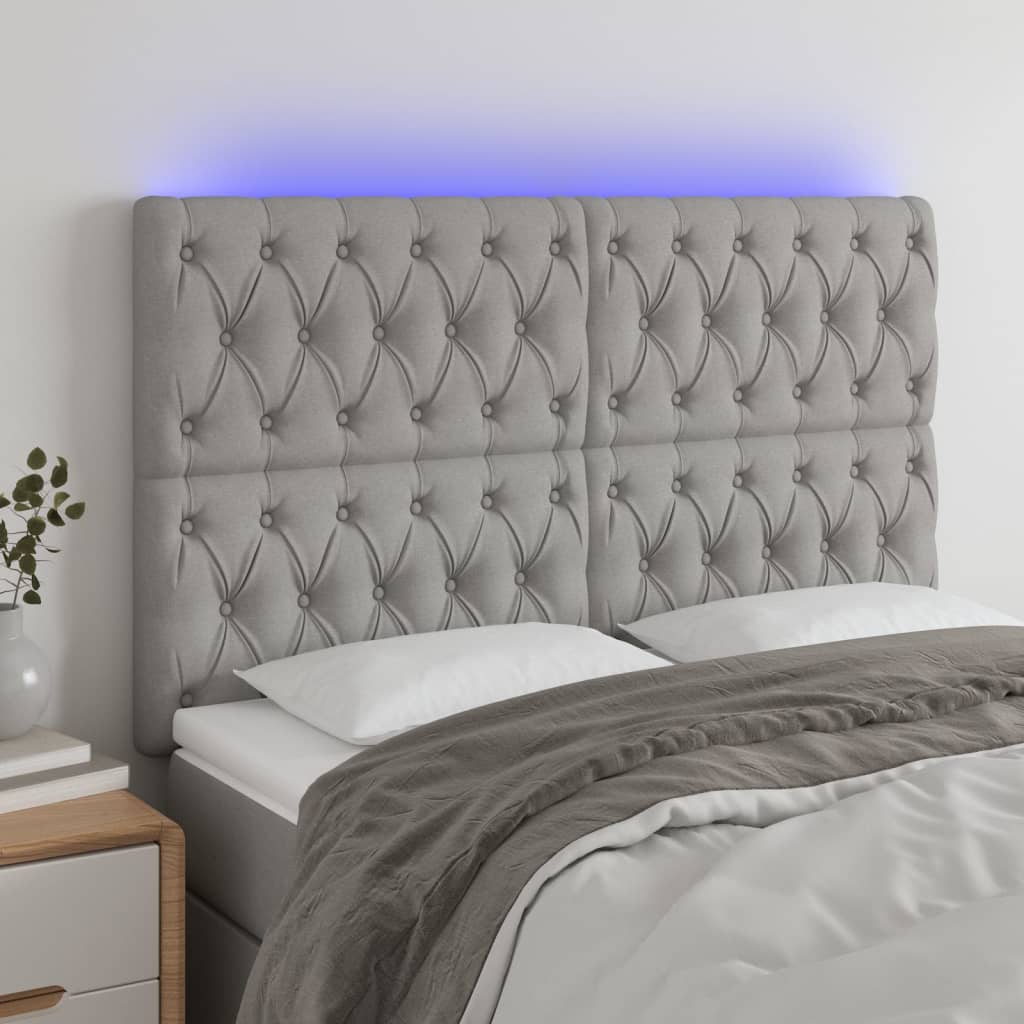 sengegavl med LED-lys 144x7x118/128 cm stof lysegrå