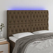 sengegavl med LED-lys 160x7x118/128 cm stof mørkebrun