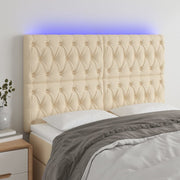 sengegavl med LED-lys 160x7x118/128 cm stof cremefarvet