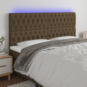 sengegavl med LED-lys 180x7x118/128 cm stof mørkebrun