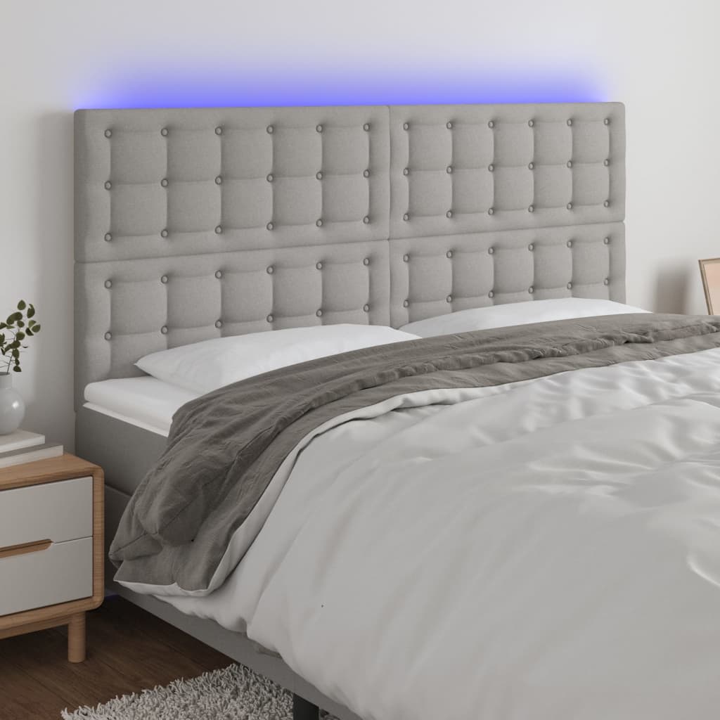 sengegavl med LED-lys 160x5x118/128 cm stof lysegrå