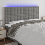 sengegavl med LED-lys 160x5x118/128 cm stof mørkegrå