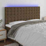 sengegavl med LED-lys 200x5x118/128 cm stof mørkebrun