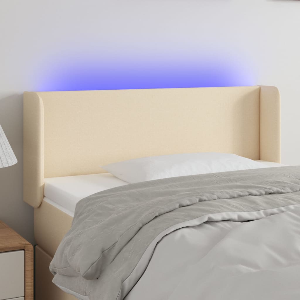 sengegavl med LED-lys 93x16x78/88 cm stof cremefarvet