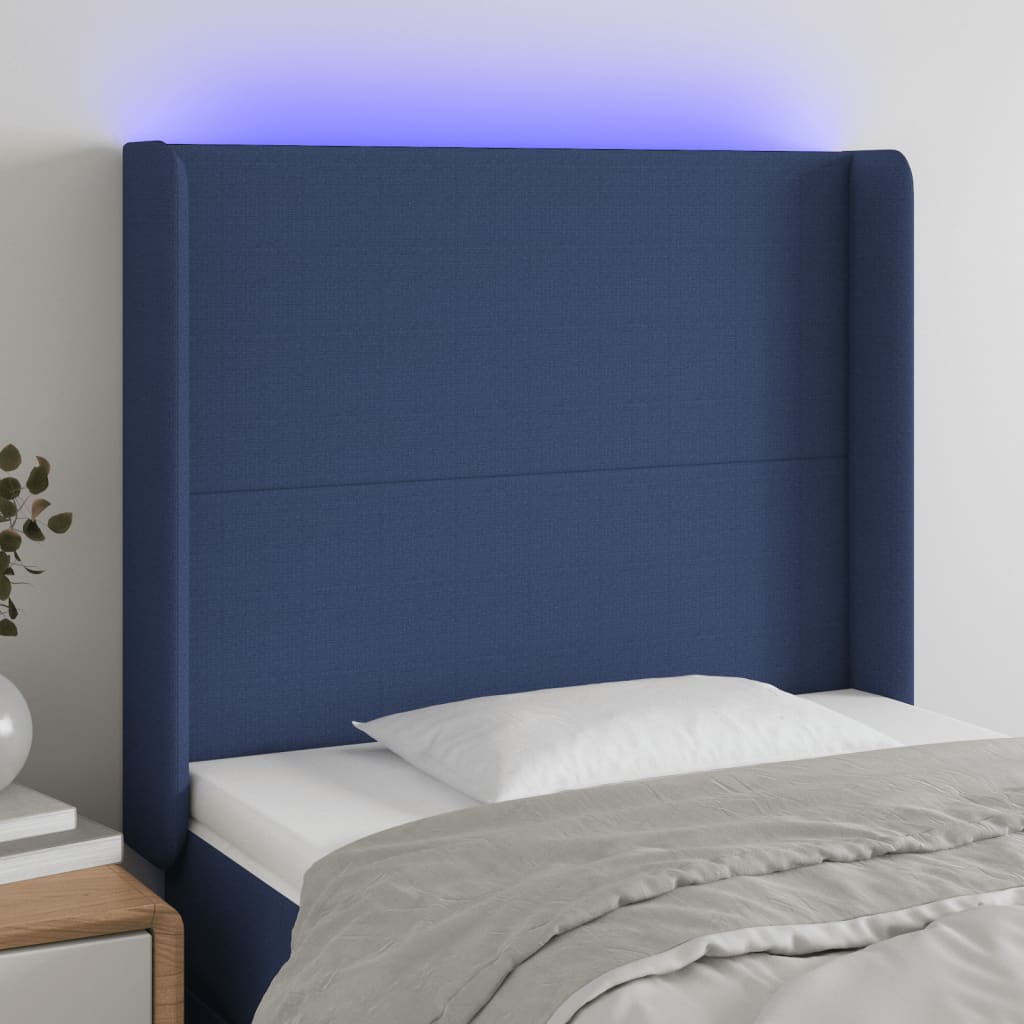 sengegavl med LED-lys 83x16x118/128 cm stof blå