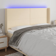 sengegavl med LED-lys 183x16x118/128 cm stof cremefarvet