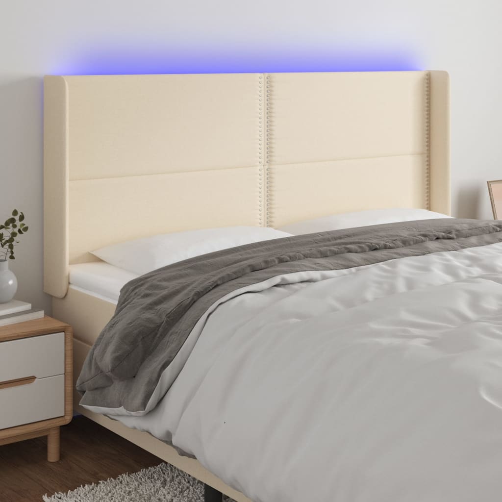 sengegavl med LED-lys 183x16x118/128 cm stof cremefarvet