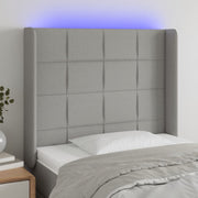sengegavl med LED-lys 83x16x118/128 cm stof lysegrå