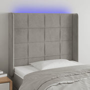 sengegavl med LED-lys 83x16x118/128 cm fløjl lysegrå