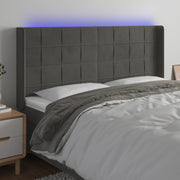 sengegavl med LED-lys 163x16x118/128 cm fløjl mørkegrå