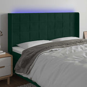sengegavl med LED-lys 203x16x118/128 cm fløjl mørkegrøn
