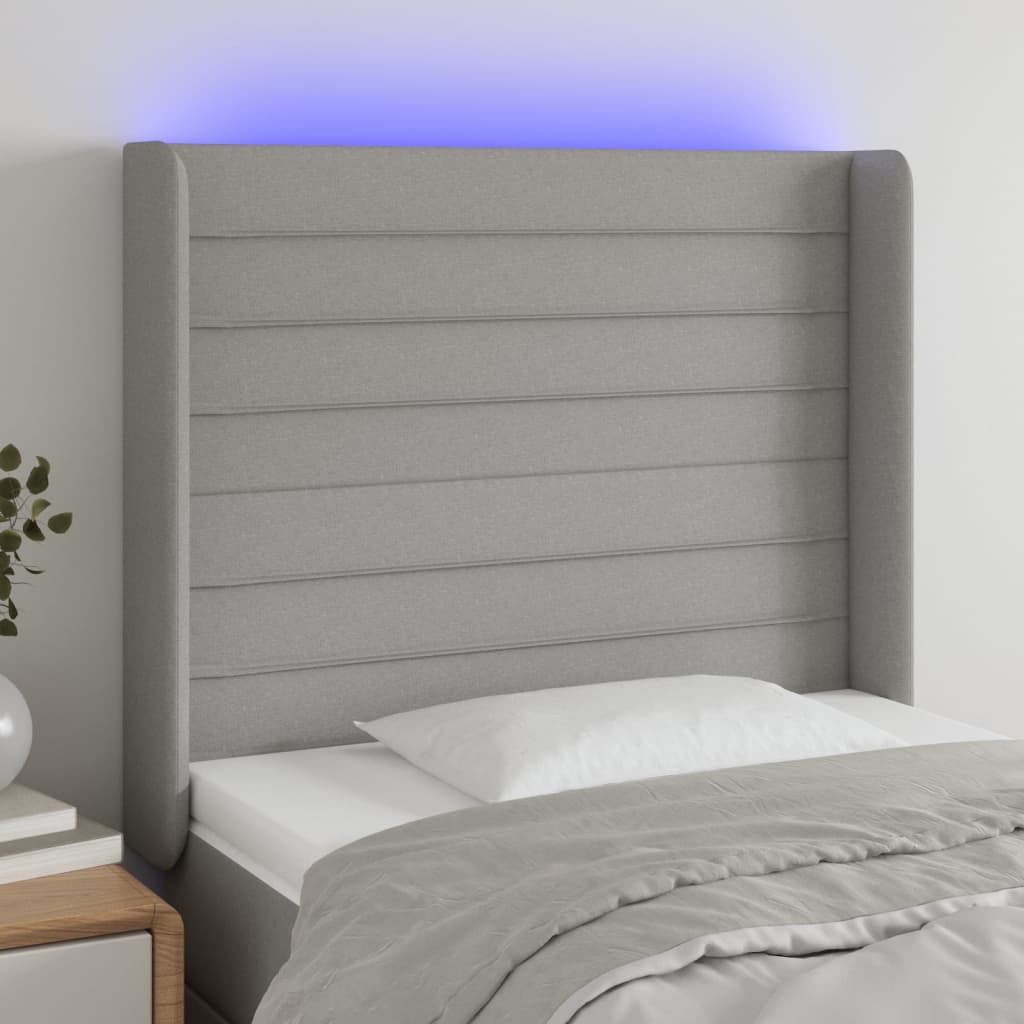 sengegavl med LED-lys 83x16x118/128 cm stof lysegrå
