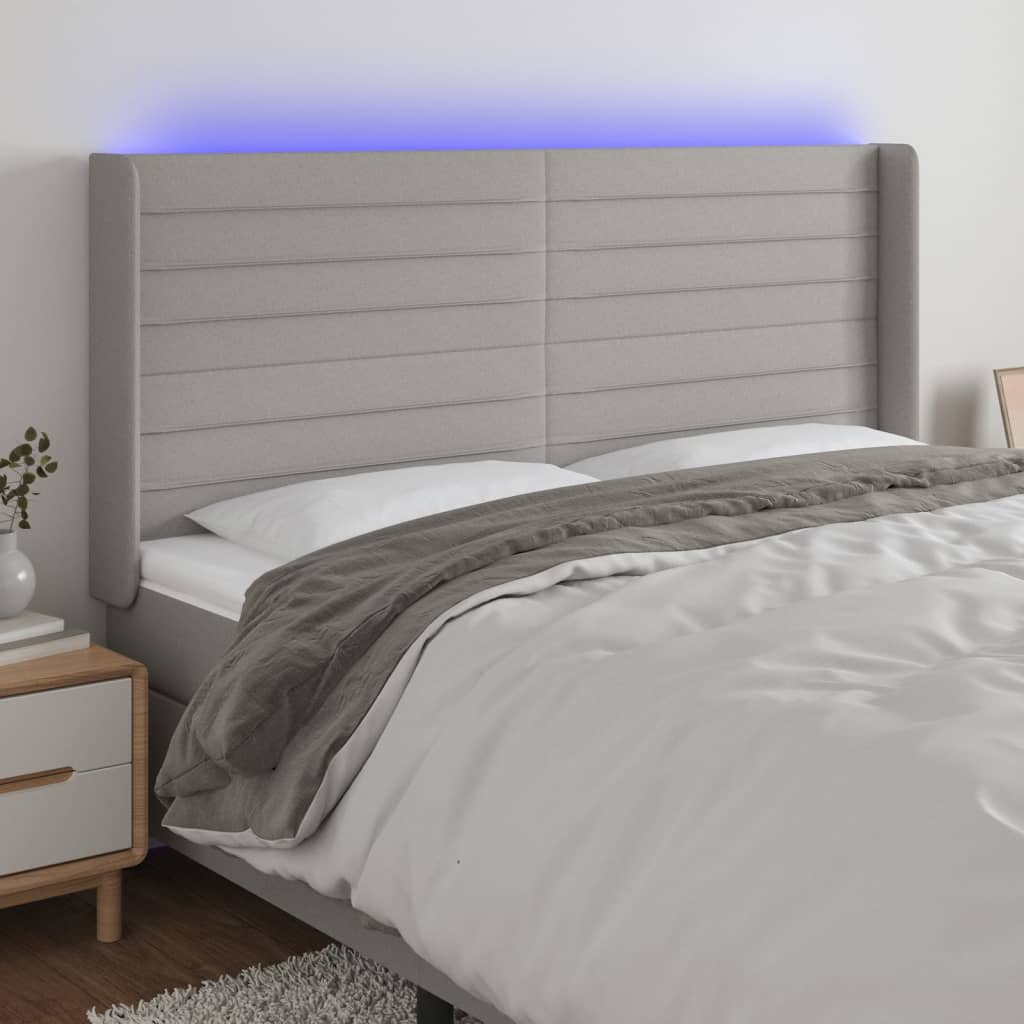 sengegavl med LED-lys 183x16x118/128 cm stof lysegrå
