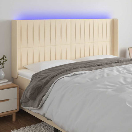 sengegavl med LED-lys 163x16x118/128 cm stof cremefarvet