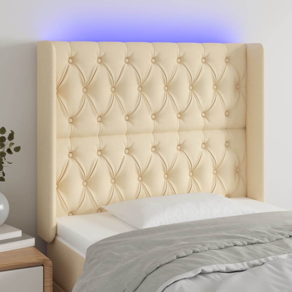 sengegavl med LED-lys 93x16x118/128 cm stof cremefarvet