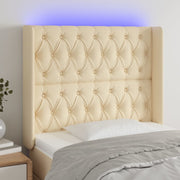 sengegavl med LED-lys 93x16x118/128 cm stof cremefarvet