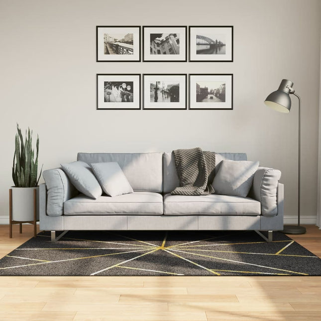 gulvtæppe 120x180 cm vaskbart sort + guldfarvet